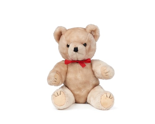 Preview: Small brown teddy bear sits on a white isolated background