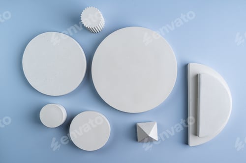 Preview: White geometric podiums made of concrete circles of different forms and pyramids