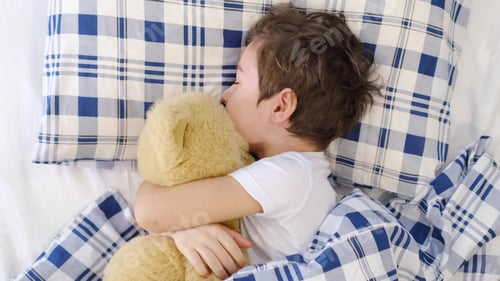 Preview: little kid boy sleeping in bed with toy. Cute healthy little toddler baby boy