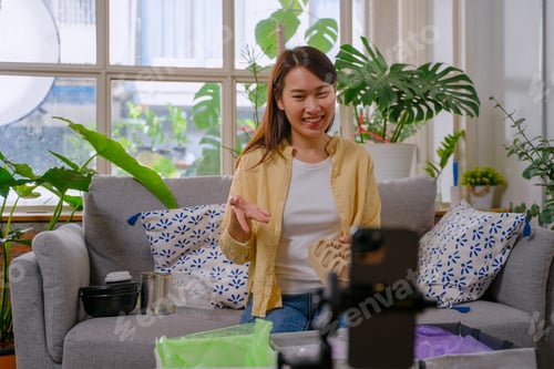 Preview: The East Asian woman is choosing garbage for recycle.