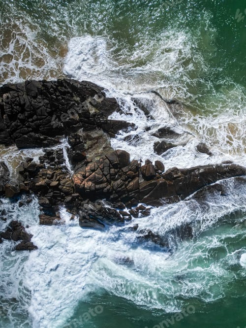 Preview: Peaceful coastal scene featuring a rocky shoreline with crystal clear water in shades of turquoise