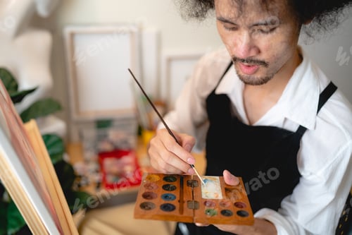Preview: creative artist working watercolor art drawing picture with brush paint in hobby