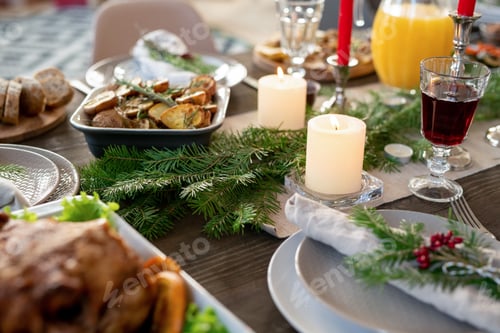 Preview: Part of festive table served with jug of orange juice, roasted potatoes, turkey