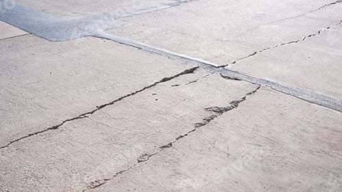 Preview: Long broken crack lines texture on surface of the old damaged concrete road floor background