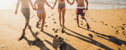 Preview: Back view people in summer holiday vacation running on the sand at the beach to the water
