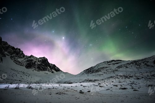 Preview: Aurora borealis with sunrise shining over mountain range in the night sky