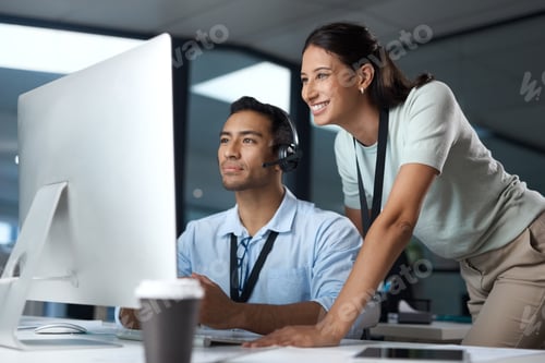 Preview: Shot of a young man and woman using a computer while working in a call centre
