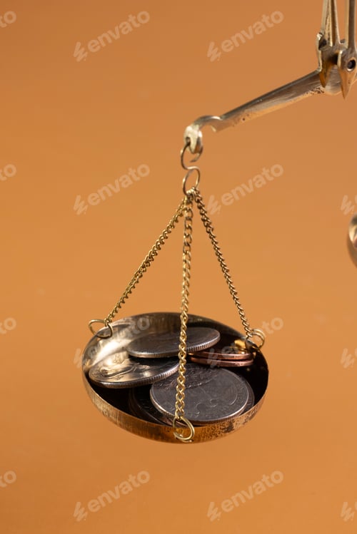 Preview: Close-up of gold coins on brass scales, importance and weight of money