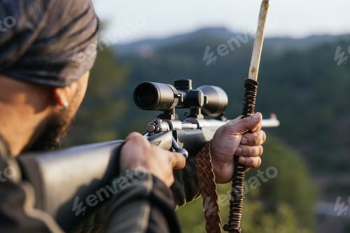Preview: Hunter aiming with rifle in nature