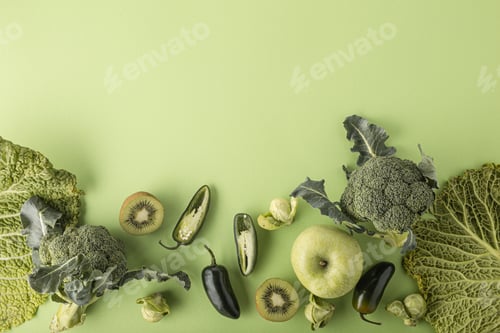 Preview: Creative layout food concept made of green fruit and vegetables on green background