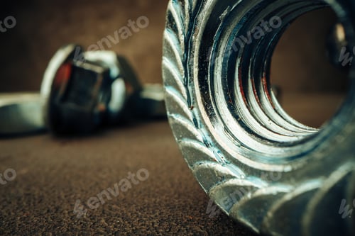 Preview: Macro shot of metal nuts on textured surface