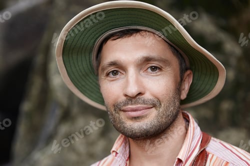 Preview: Ecology and environmental conservation concept. Joyful middle aged biologist wearing panama looking