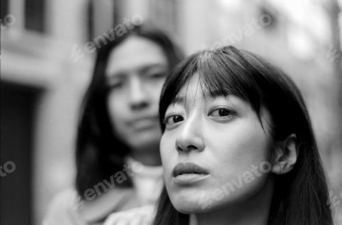 Preview: Grainy analog portrait of young couple with serious expressions