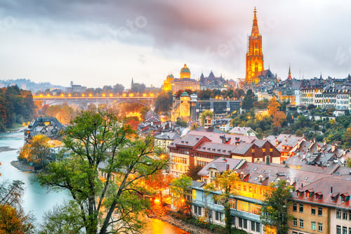Preview: Amazing autumn view of Bern city on Aare river during evening with Cathedral of Bern on background.