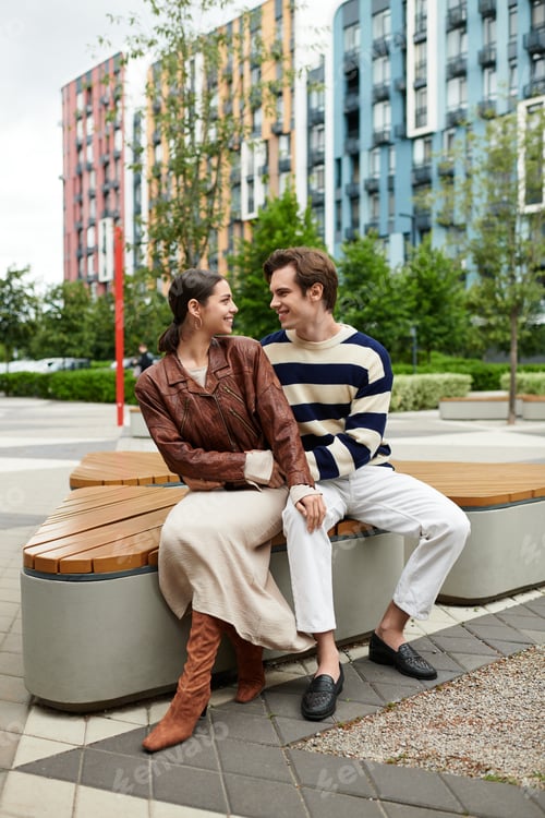 Preview: Young couple enjoys a joyful moment together at a vibrant urban park on a sunny day