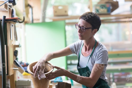 Preview: Woman in workshop polishing alphorn