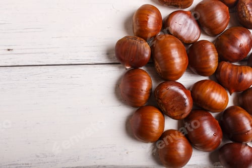 Preview: pile of sweet chestnuts on white wooden background