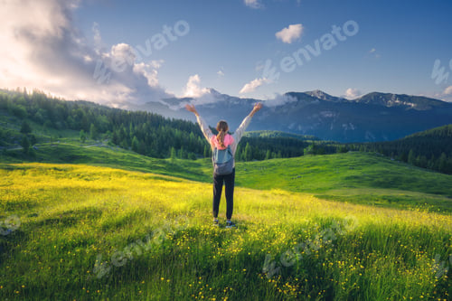 Preview: Happy girl on the hill with yellow flowers and green grass
