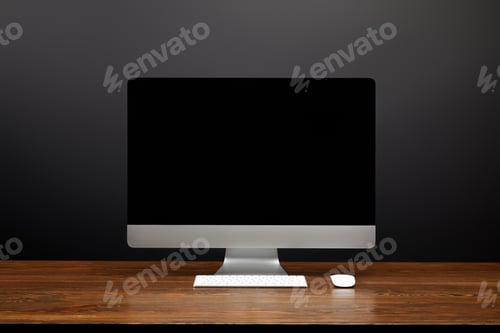Preview: close up view of designer workplace with blank computer screen and computer mouse on wooden tabletop