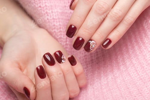 Preview: Shot beautiful manicure with flowers on female fingers. Nails design. Close-up