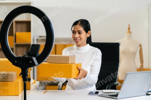 Preview: Asia vlogger woman influencer, SME retail store owner smile enjoy selling show live sale online