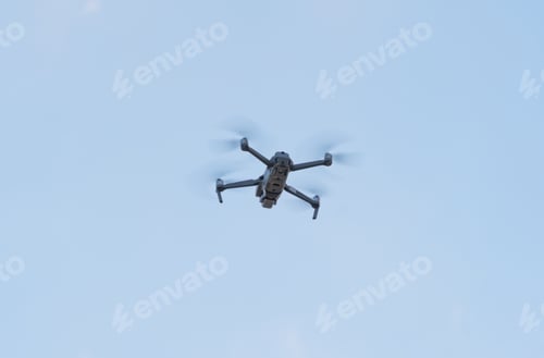 Preview: Aerial view of a drone with propellers flying with camera