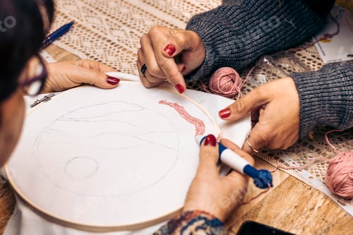 Preview: Close-up of the hands of two women weaving. Punch Needle Workshop. Needlework.