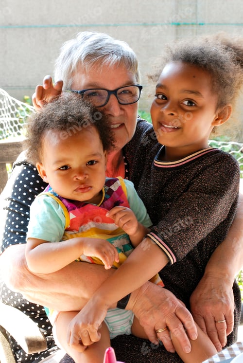 Preview: Grandmother holding her granddaughters diversity mixed race family love
