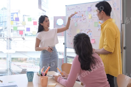 Preview: Attractive businesswoman giving presentation to her business colleagues in the conference room.