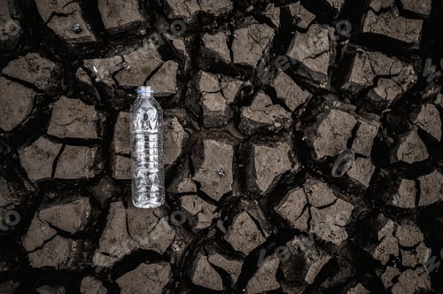 Preview: Water bottles on dry soil with dry and cracked soil,global warming