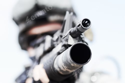 Preview: War weaponry. Closeup selective focus of the barrel of a gun.