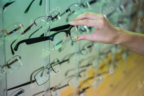 Preview: Woman shopping for new glasses at the optometry store