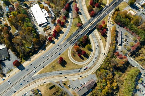 Preview: Aerial view of american freeway intersection with fast moving cars and trucks.