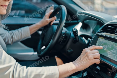 Preview: Close up of woman using global positioning system while driving car