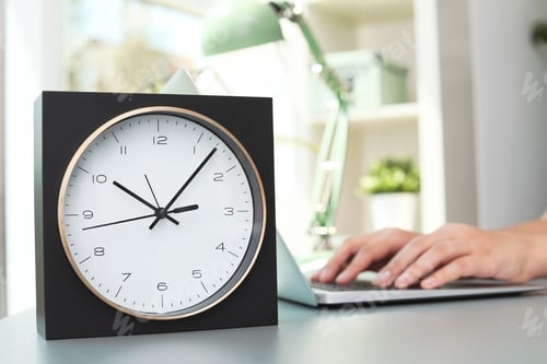 Preview: Stylish analog clock on table in office. Time to work