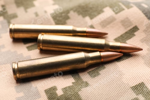 Preview: Military bullets on pixel Ukrainian camouflage, closeup