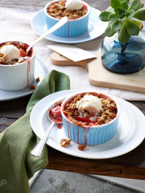 Preview: Still life of rhubarb, apple and strawberry crumble with ice cream