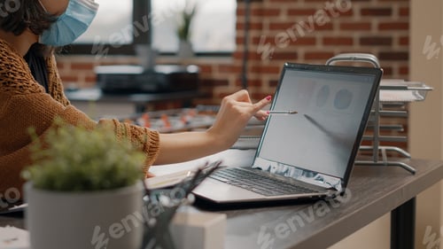 Preview: Close up of employee working with laptop and documents