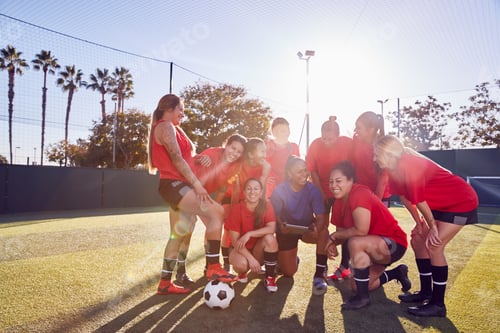 Preview: Coach With Digital Tablet Discussing Tactics With Womens Football Team Training For Soccer Match