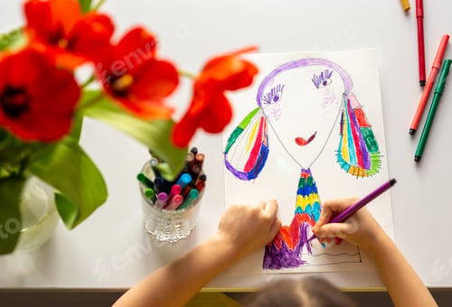 Preview: Close-up of girl's hands draw a portrait of mom