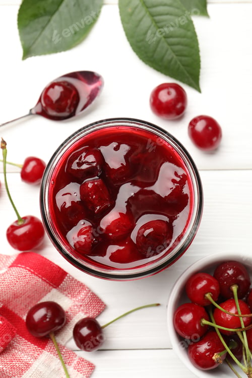 Preview: Tasty cherry jam and fresh fruits on white wooden table, flat lay