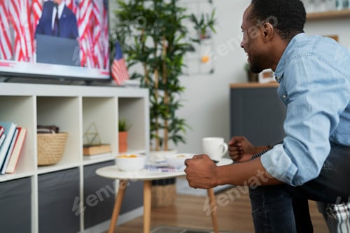 Preview: Extremely happy man watching TV