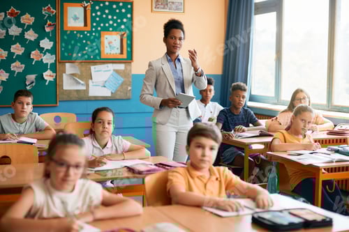 Preview: African American teacher giving a lecture to her students at elementary school.