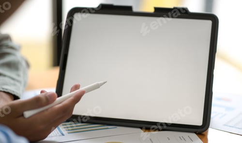 Preview: Businessman hand pointing pen at digital tablet to present the project to customers.