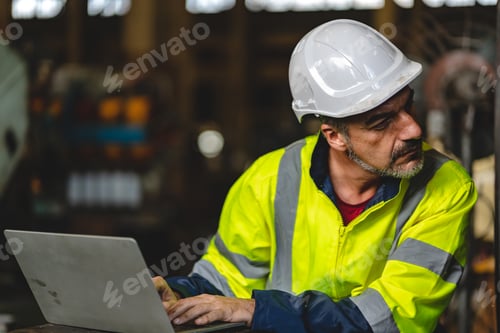 Preview: professional technician engineer with safety hard hat working to maintenance construction equipment