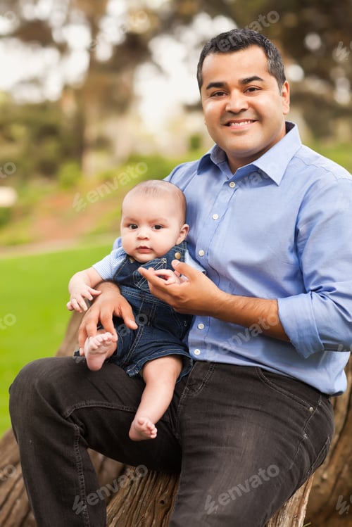 Preview: Handsome Hispanic Father and Son Posing for A Portrait in the Park.
