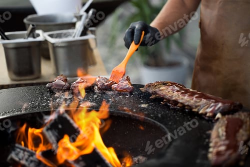 Preview: Chicken wings on barbecue grill street food outdoors festival