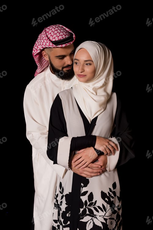 Preview: beautiful embracing muslim couple isolated on black