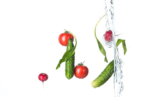 Preview: The fresh tomatos, cucumbers, radish in spray of water.