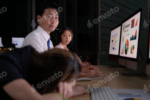 Preview: Group of broker international stock traders wearing headset working actively at night in office,